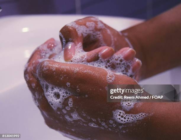 woman washing her hand - lifestyle stock pictures, royalty-free photos & images