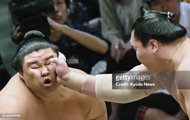 Shodai receives a slap to the face from Hakuho at the outset of a bout on July 11 the third day of the Nagoya Grand Sumo Tournament in Nagoya,...