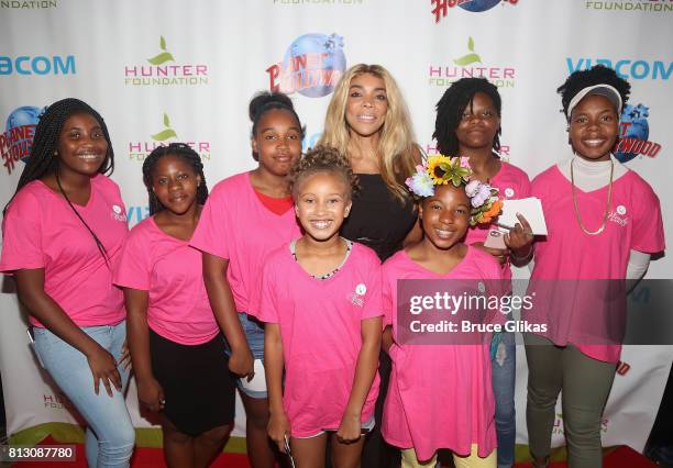 Wendy Williams poses with Hunter Foundation Kids at a celebration for her Hunter Foundation Charity that helps fund programs for families and youth...