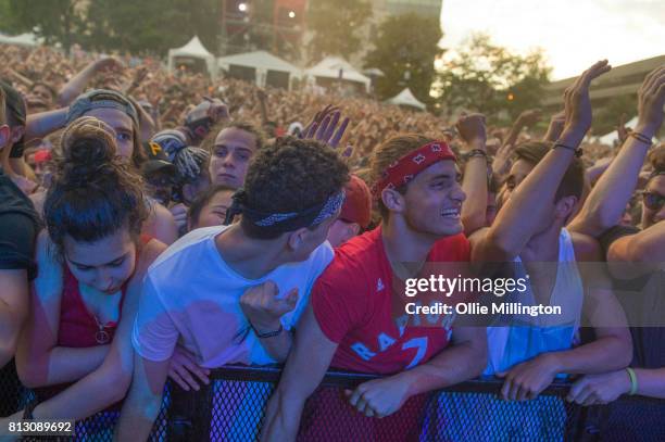 The crowd watch on as Jazz Cartier performs on the Lotto Stage in the Parc de la Francophoni during Day 6 of the 50th Festival d'ete de Quebec on...