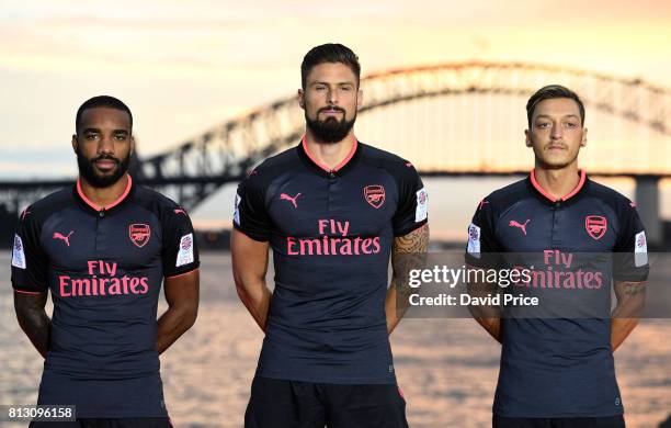 Alexandre Lacazette, Olivier Giroud and Mesut Ozil of Arsenal launch the new Puma Arsenal 3rd kit on Fort Dennison on July 12, 2017 in Sydney,...