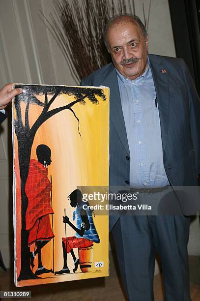 Maurizio Costanzo shows a painting he has bought at the auction Art For Peace in support of Soleterre Strategie di Pace charity organization at the...