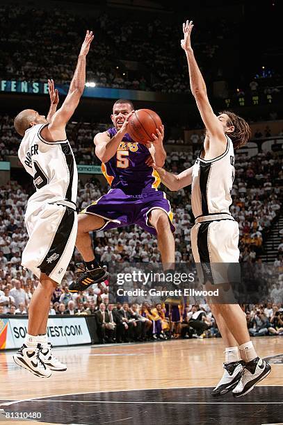 Jordan Farmar of the Los Angeles Lakers jumps up to pass in between Tony Parker and Fabricio Oberto of the San Antonio Spurs in Game Four of the...