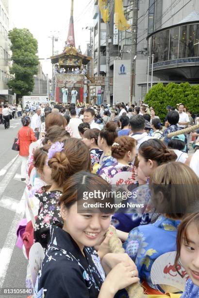 People haul a Hoko float in Kyoto on July 12 prior to the Yamahoko procession in the Gion Festival on July 17. ==Kyodo