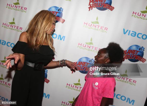 Wendy Williams chats with a foundation kid at a celebration for her Hunter Foundation Charity that helps fund programs for families and youth...