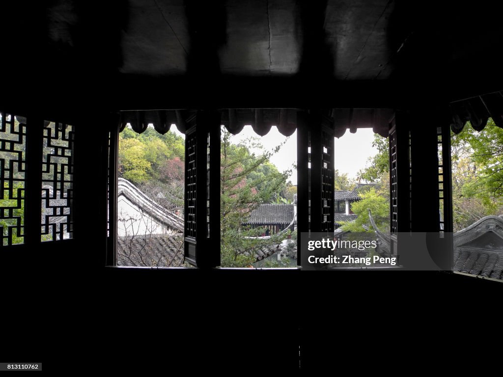 Chinese traditional tiled roofs, seen from wooden carved...