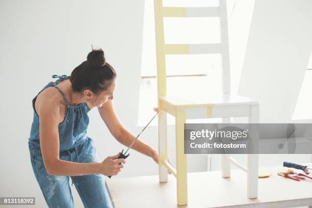 mid adult woman painting chair - restoring chair stock pictures, royalty-free photos & images