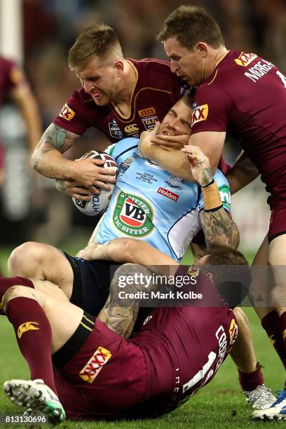 Josh Dugan of the Blues is tackled during game three of the State Of Origin series between the Queensland Maroons and the New South Wales Blues at...