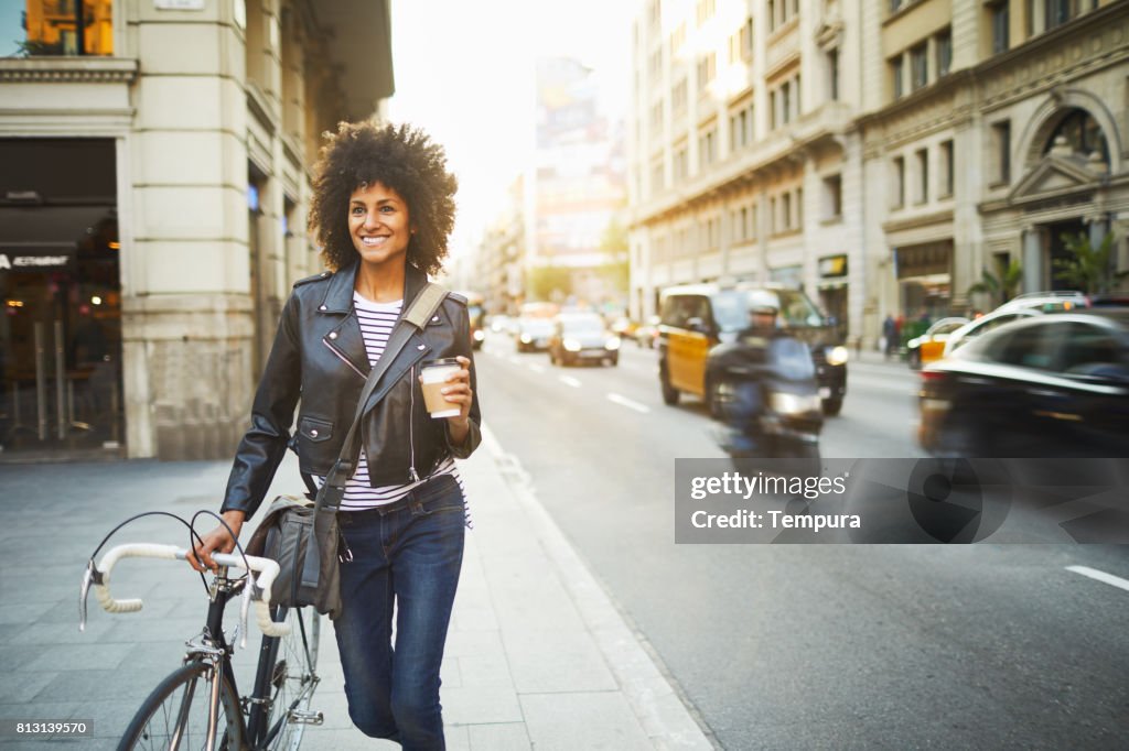 Young hipster woman in the streets of Barcelona commuting.