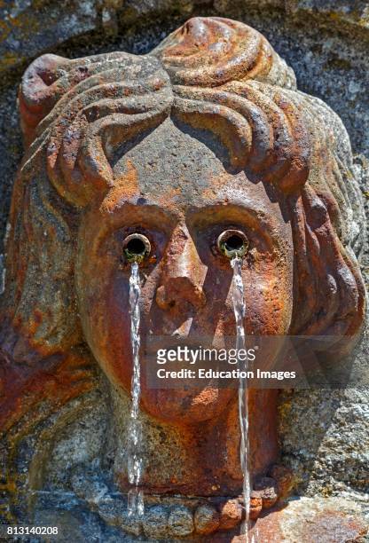 Braga, Braga District, Portugal. Bom Jesus do Monte sanctuary. Face of crying woman on fountain on the Baroque staircase.
