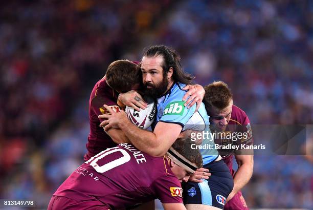 Aaron Woods of the Blues takes on the defence during game three of the State Of Origin series between the Queensland Maroons and the New South Wales...