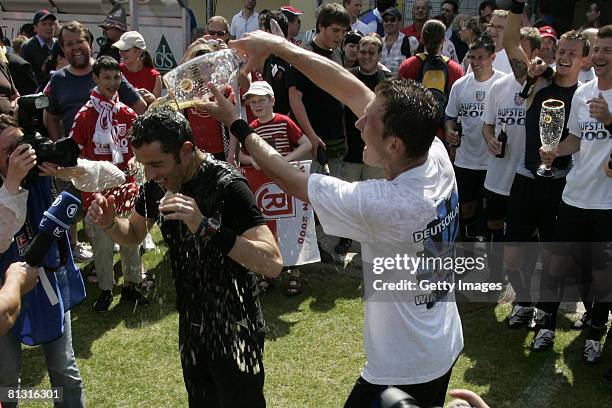 Trainer Tomas Oral of FSV Frankfurt gets a beer shower when celebrating the ascention to the 2. Bundesliga after the 3. Bundesliga match between SSV...