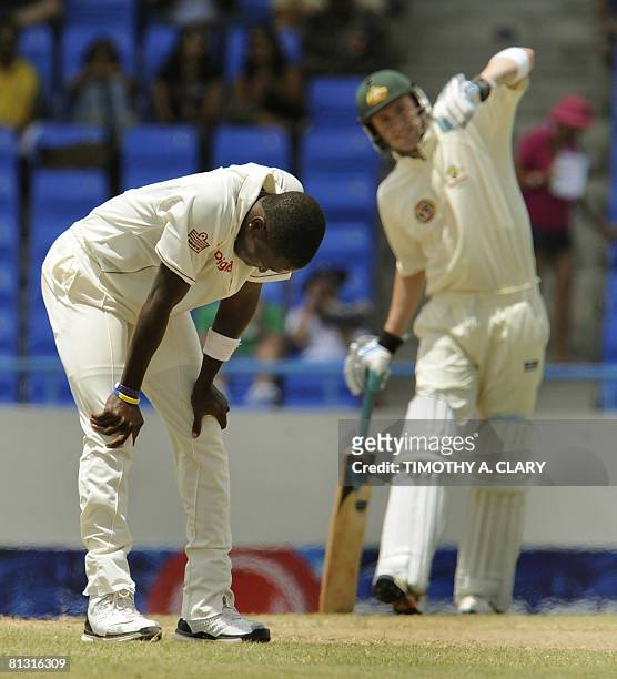 West Indies bowler Fidel Edwards hangs his head as Australia batsman Michael Clarke looks on during the 2008 Digicel Home Series at the Sir Vivian...