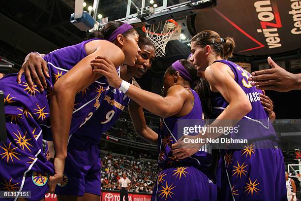 Lisa Leslie of the Los Angeles Sparks conferences with other players after a foul against the Washington Mystics at the Verizon Center on May 31,...