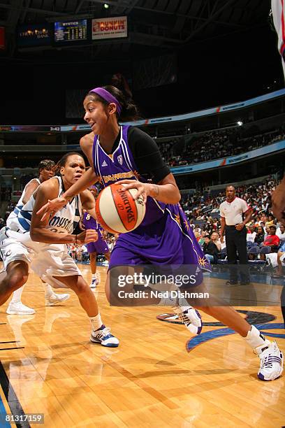 Candace Parker of the Los Angeles Sparks drives against Monique Currie of the Washington Mystics at the Verizon Center on May 31, 2008 in Washington,...