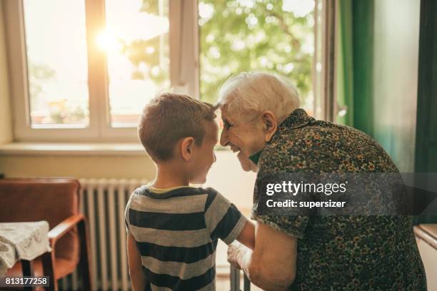 grandson visiting his granny in nursery - great grandmother stock pictures, royalty-free photos & images