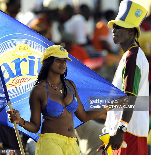 West Indies fan and a Carib Beer girl look up at the scoreboard after another West Indies out in the 2nd innings during the 2008 Digicel Home Series...