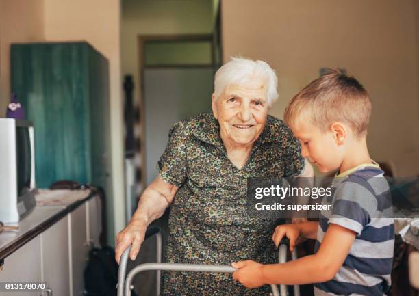 grandson visiting his granny in nursery - great grandmother stock pictures, royalty-free photos & images