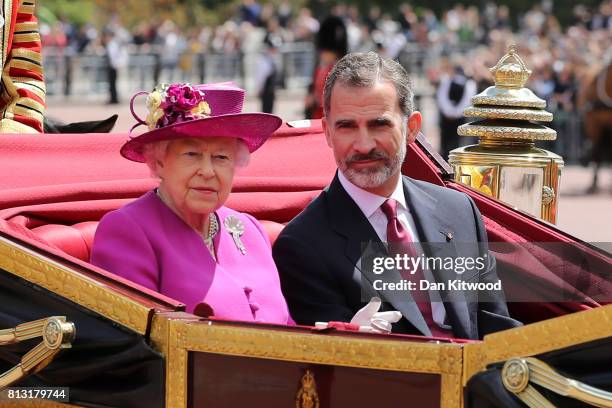 Queen Elizabeth II and King Felipe VI of Spain ride in a carriage during a State visit by the King and Queen of Spain at Centre Gate, Buckingham...