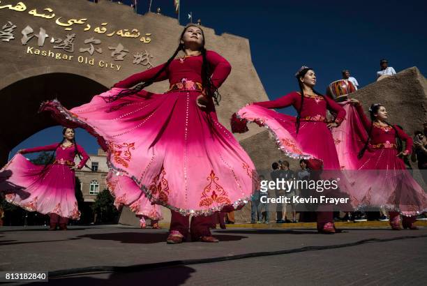 Ethnic Uyghur women dance for Chinese tourists on June 29, 2017 in the old town of Kashgar, in the far western Xinjiang province, China. Kashgar has...