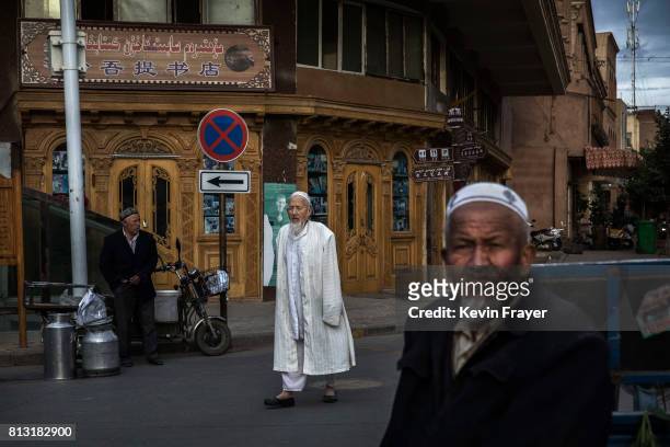 Ethnic Uyghur men are seen in the street at a local market on July 1, 2017 in the old town of Kashgar, in the far western Xinjiang province, China....