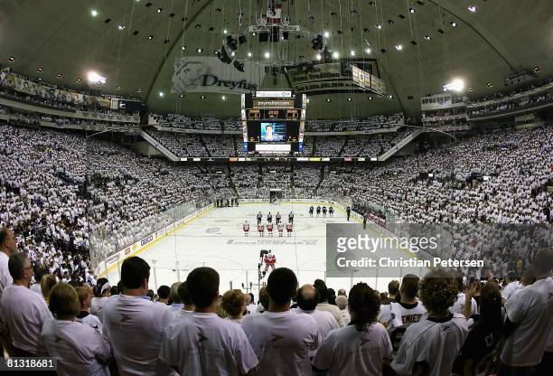 Fans and players of the Detroit Red Wings and the Pittsburgh Penguins observe a moment of silence for Luc Bourdon of the Vancouver Canucks, who was...