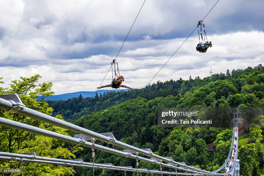 Zipline Riders Along The Longest Hanging Bridge In The World zipline-riders-along-the-longest-hanging-bridge-in-the-world