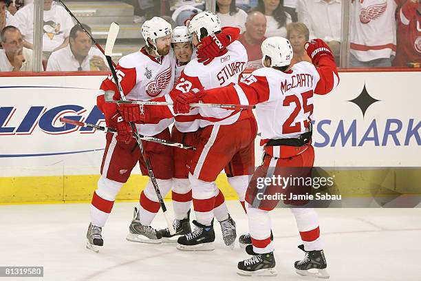 Jiri Hudler of the Detroit Red Wings celebrates with teammates Brad Stuart, Darren McCarty and Niklas Kronwall Hudler scored a third period goal past...