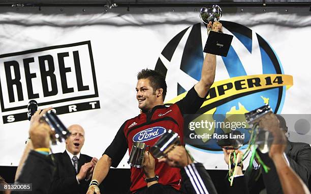 Crusaders captain Richie McCaw holds the Super 14 trophy aloft following the Crusaders win over the Waratahs in the Super 14 final at AMI Stadium on...