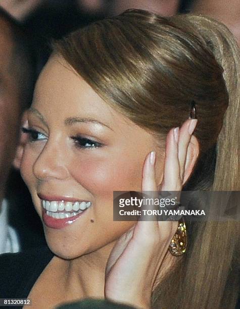 Pop star Mariah Carey waves to Japanese fans during an event to promote her new album "E=MC2" in Tokyo on June 1, 2008. Carey is here to attend the...