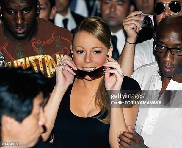 Pop star Mariah Carey puts on sunglasses during a fan event to promote her new album "E=MC2" in Tokyo on June 1, 2008. Carey is here to attend the...