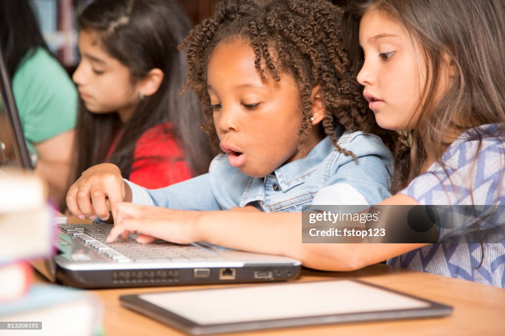 Elementary-age children learn computer coding in school.