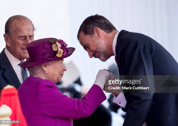 Queen Elizabeth II greets King Felipe VI of Spain at the official welcome ceremony on Horseguards Parade during a State visit by the King and Queen...