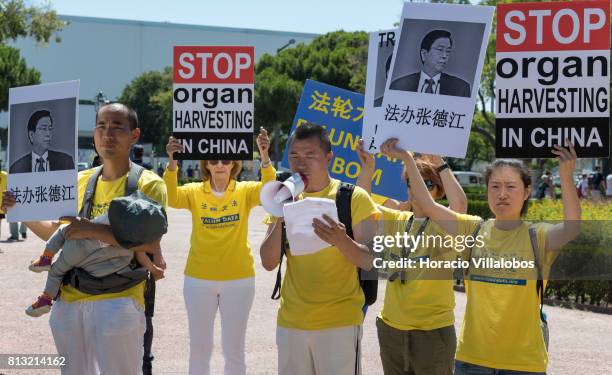 Members of the Portuguese chapter of Falun Dafa, a spiritual practice banned in China since 1999, demonstrate outside Belem Palace against organ...