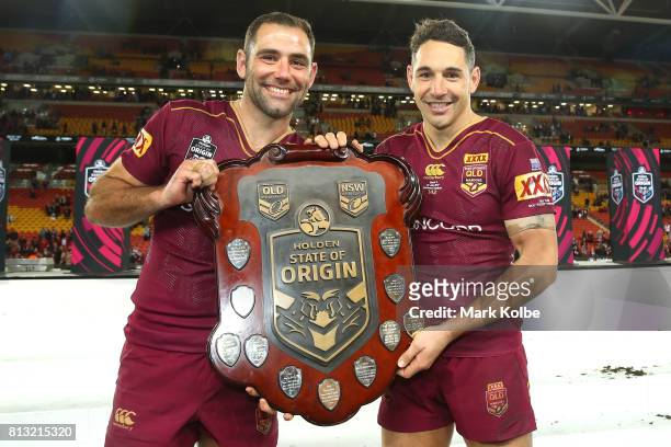 Cameron Smith and Billy Slater of the Maroons pose with the shield as they celebrate victory during game three of the State Of Origin series between...