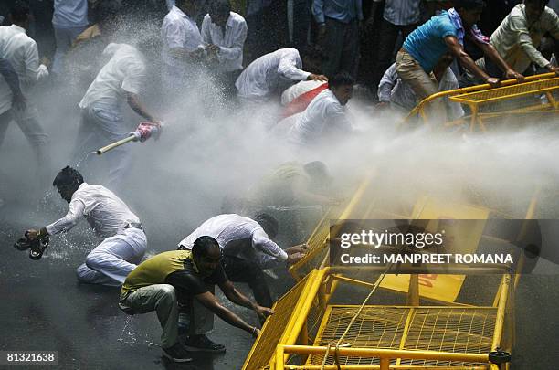 Indian police use a water canon to disperse Gujjar protesters during a protest in New Delhi on June 1, 2008. Agreeing to the demand of the Gujjars,...