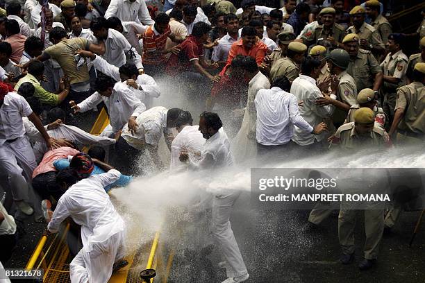 Indian police use a water canon to disperse Gujjar protesters during a protest in New Delhi on June 1, 2008. Agreeing to the demand of the Gujjars,...