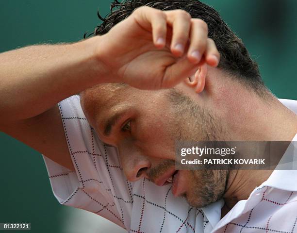 French player Michael Llodra gets ready to serve to Latvian player Ernests Gulbis during their French tennis Open fourth round match at Roland...