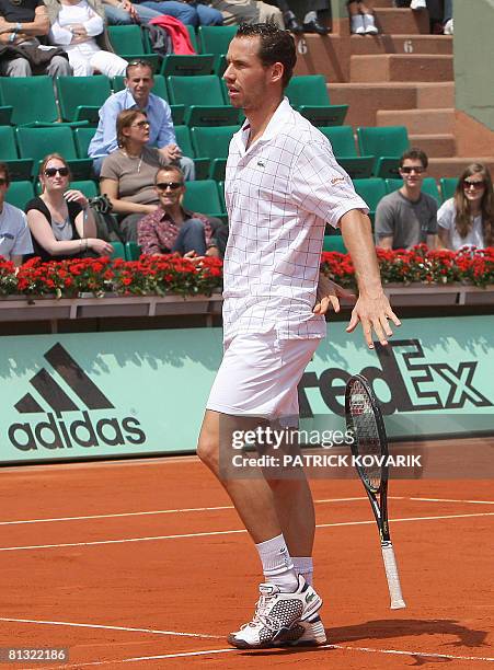 French player Michael Llodra drops his racket after losing a point against Latvian player Ernests Gulbis during their French tennis Open fourth round...