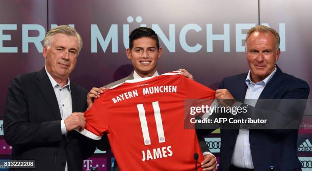 Colombian midfielder James Rodriguez , new recruit of German first division Bundesliga football club Bayern Munich, holds his new jersey as he poses...