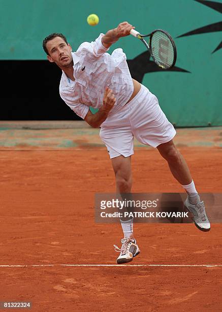 French player Michael Llodra hits a return to Latvian player Ernests Gulbis during their French tennis Open fourth round match at Roland Garros, on...