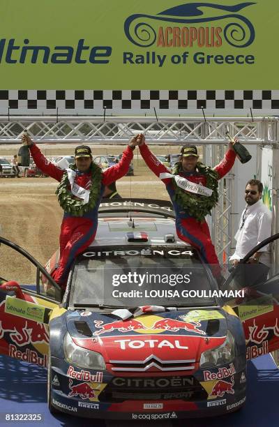 French Sebastien Loeb with Monaco's Daniel Elena celebrate on their Citroen C4 after winning the 55th Acropolis Rally in Greece as part of the World...