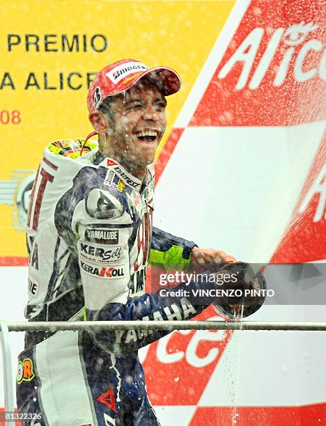 Italian seven-time former world champion Valentino Rossi sprays champagne on the podium after winning his home Moto Grand Prix at Mugello for the...