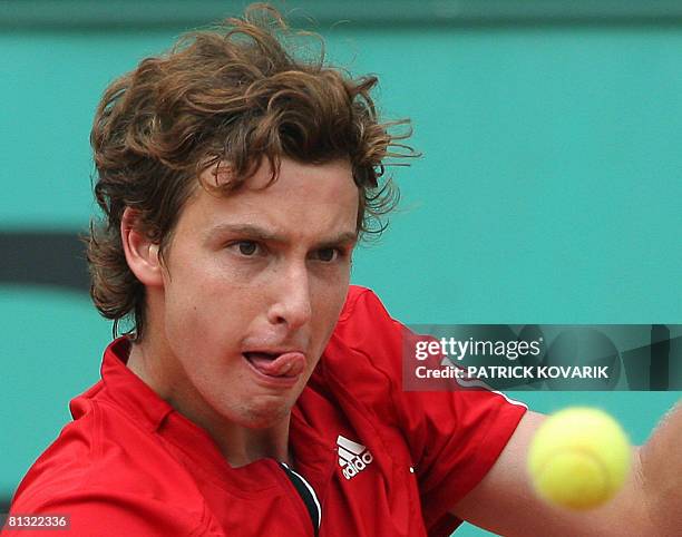 Latvian player Ernests Gulbis eyes the ball for a return to French player Michael Llodra during their French tennis Open fourth round match at Roland...