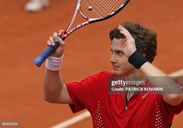 Latvian player Ernests Gulbis reacts after winning against French player Michael Llodra during their French tennis Open fourth round match at Roland...