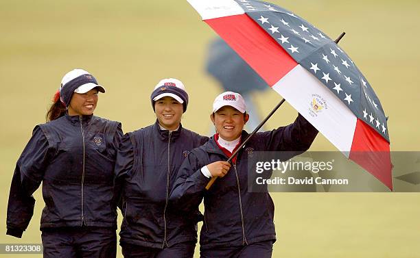 Team members Mina Harigae, Kimberly Kim and Jennie Lee walk happily up the 18th fairway during the final day singles matches for the 2008 Curtis Cup...