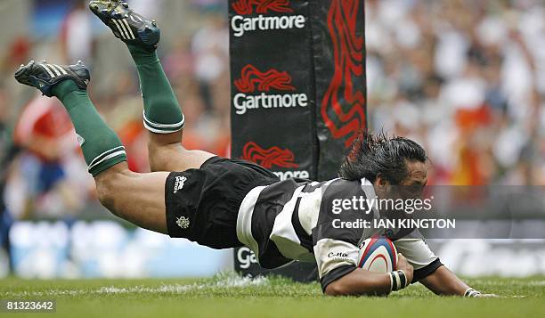 Barbarian's Samoan player Seilala Mapusua scores a try between the posts during the Gartmore Challenge Rugby Union international match against...