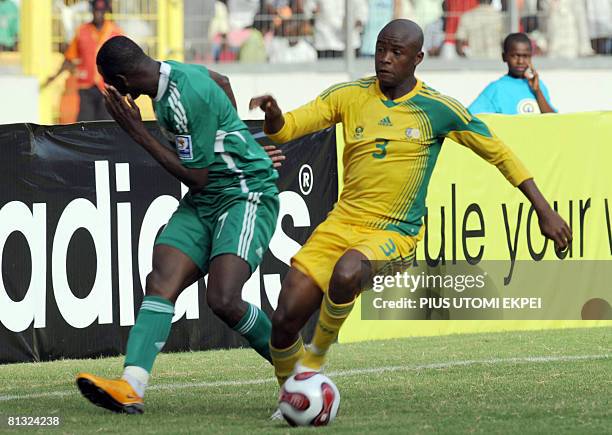 South African Tsepo Masilea collects the ball after hitting the face of Nigerian attacker John Utaka during FIFA 2010 World Cup and Africa Cup of...