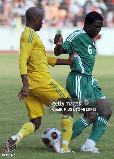 South African Tsepo Masilea tries to stop Nigeria's Mohammed Yusuf during FIFA 2010 World Cup and Africa Cup of Nations qualifying match in Abuja on...