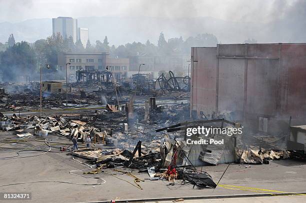 Smoking debris is seen after approximately 400 firefighters from the Los Angeles area battled a huge fire on the backlot of Universal Studios June 1,...